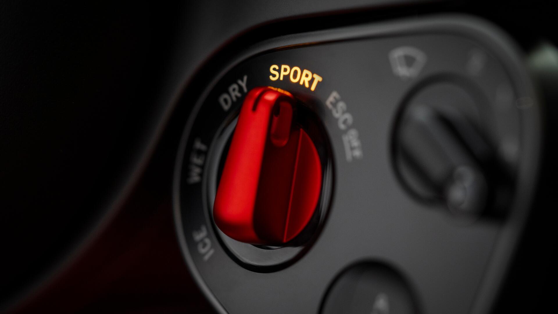 4K Ultra HD PC desktop wallpaper: close-up of a Ferrari Luce vehicle interior, focusing on a red SPORT drive-mode selector knob.