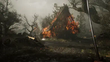 4K Ultra HD PC desktop wallpaper from the video game Valor Mortis: a burning A-frame house amid charred trees and a smoky battlefield, embers glowing beneath a stormy sky.