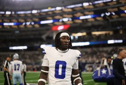 4K Ultra HD wallpaper of an NFL football player in a Dallas Cowboys white No. 0 uniform standing on the stadium field.