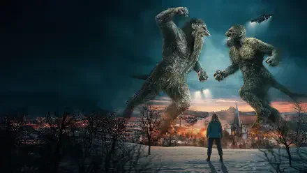 Troll 2 4K Ultra HD PC desktop wallpaper: two towering trolls clash over a lit village while a lone figure watches from a snowy ridge beneath a stormy sky.