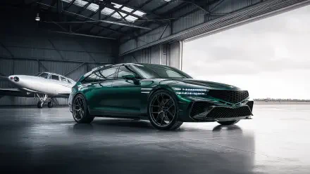 Green Genesis G90 parked in an aircraft hangar with glossy finish and sporty wheels, 4K Ultra HD PC desktop wallpaper background.