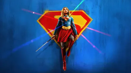 Movie Supergirl (2026) 4K Ultra HD PC desktop wallpaper: Supergirl hovers in a red-and-blue suit before a giant S emblem with neon light streaks on a blue backdrop.