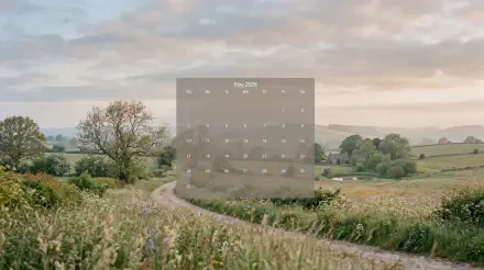 May 2026 calendar overlay on a 5K Ultra HD PC desktop wallpaper background of a winding country lane through green fields under a soft cloudy sky.