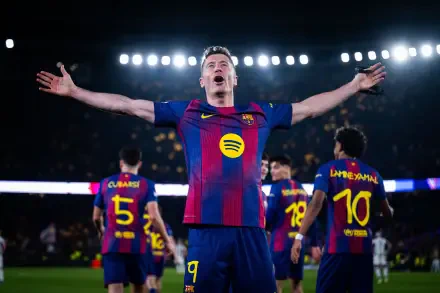 FC Barcelona player celebrates with arms outstretched as teammates gather under stadium lights — 4K Ultra HD soccer PC desktop wallpaper