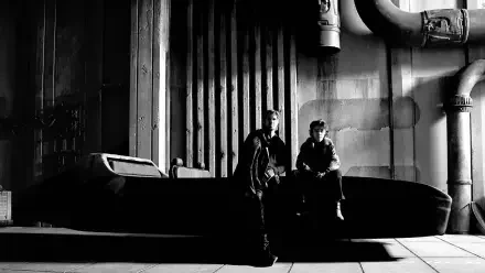 Monochrome 4K Ultra HD PC desktop wallpaper showing two figures beside a sleek Star Wars: Starfighter in an industrial hangar with dramatic shadows