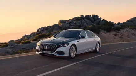 Silver Mercedes‑Maybach S 680 parked on a coastal road at sunset — 4K Ultra HD PC desktop wallpaper/background.