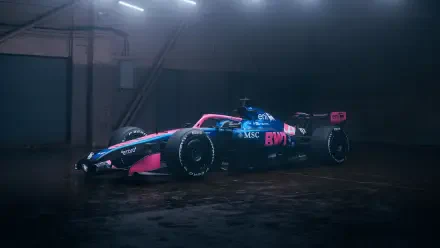 Alpine F1 Team race car in pink-and-blue livery parked under industrial lights in a dark garage, high-detail 4K Ultra HD PC desktop background.