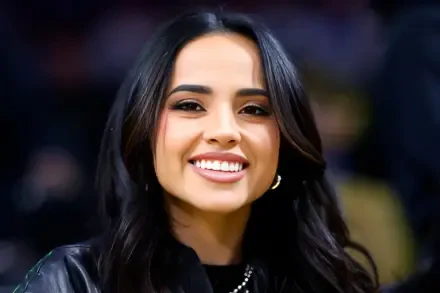 Close-up portrait of a smiling American singer with dark hair, music-themed 2K Quad HD PC desktop wallpaper and background.