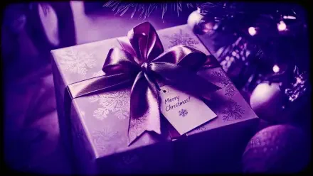 4K Ultra HD PC desktop wallpaper and background: close-up of a purple-wrapped Christmas gift with satin bow and tag beneath decorated tree ornaments.