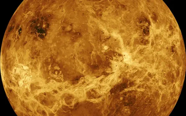 HD PC desktop wallpaper: close-up of a golden planet in space, showing textured rocky surface and swirling cloud-like formations.