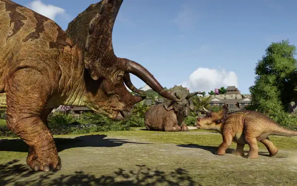 Jurassic World Evolution 3 HD PC wallpaper: adult triceratops and calf face each other in a sunlit grassy enclosure with trees, buildings, and a blue sky.