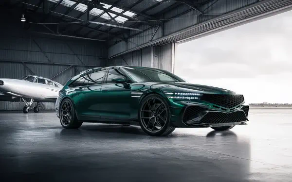 Green Genesis G90 parked in an aircraft hangar with glossy finish and sporty wheels, 4K Ultra HD PC desktop wallpaper background.