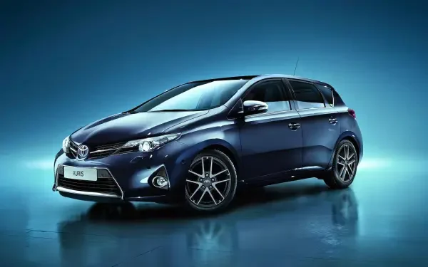 Blue Toyota Auris car, a hatchback, on a reflective surface with a blue gradient backdrop — HD PC desktop wallpaper/background.