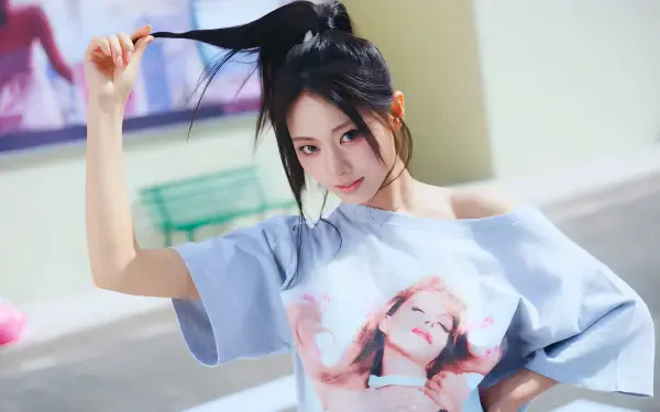 K-pop–style young woman with a high ponytail in an oversized graphic tee, playful pose on a sunlit street — 4K Ultra HD desktop wallpaper.