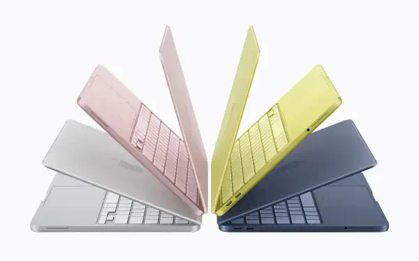 Apple Inc. MacBook and MacBook Neo laptops in pastel colors fanned outward on white, 2K Quad HD PC desktop wallpaper/background.