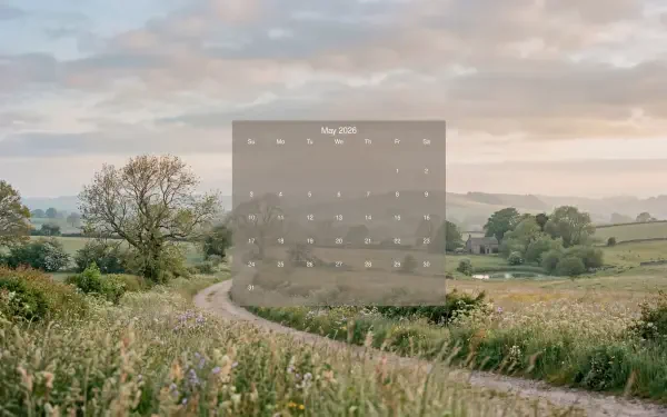 May 2026 calendar overlay on a 5K Ultra HD PC desktop wallpaper background of a winding country lane through green fields under a soft cloudy sky.