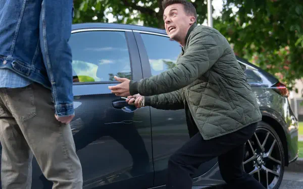 Man in green jacket opening a car door, animatedly talking to someone off-frame; 2K Quad HD desktop wallpaper inspired by TV show Malcolm in the Middle: Life's Still Unfair.
