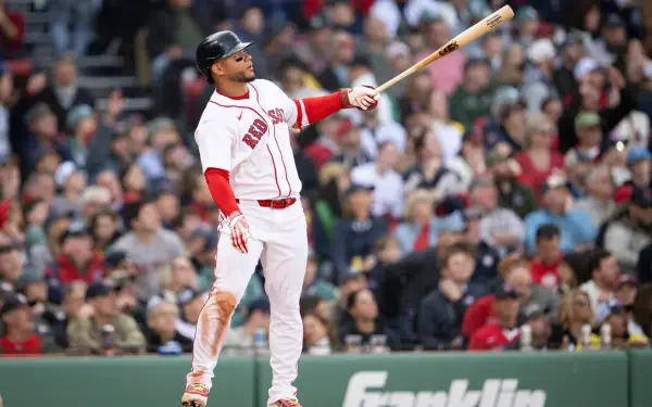 4K Ultra HD PC desktop wallpaper: MLB action — Boston Red Sox batter in white uniform swings at Fenway Park, dirt-streaked pants and a blurred stadium crowd behind.