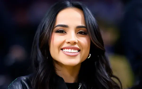 Close-up portrait of a smiling American singer with dark hair, music-themed 2K Quad HD PC desktop wallpaper and background.