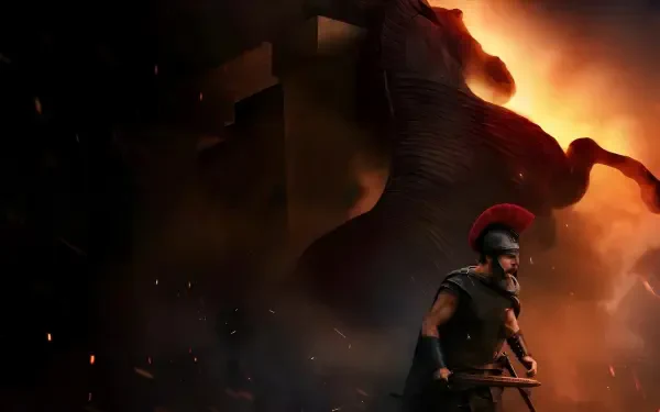 The Odyssey (2026) 4K Ultra HD PC desktop wallpaper and background: armored Greek warrior with red‑crested helmet and spear stands before a towering, fiery shadow of a wooden horse.