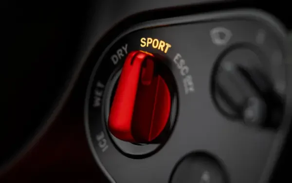 4K Ultra HD PC desktop wallpaper: close-up of a Ferrari Luce vehicle interior, focusing on a red SPORT drive-mode selector knob.