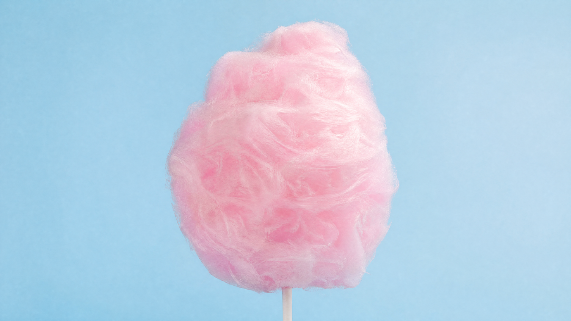4K Ultra HD PC desktop wallpaper: pink cotton candy on a stick against a soft pale blue background.