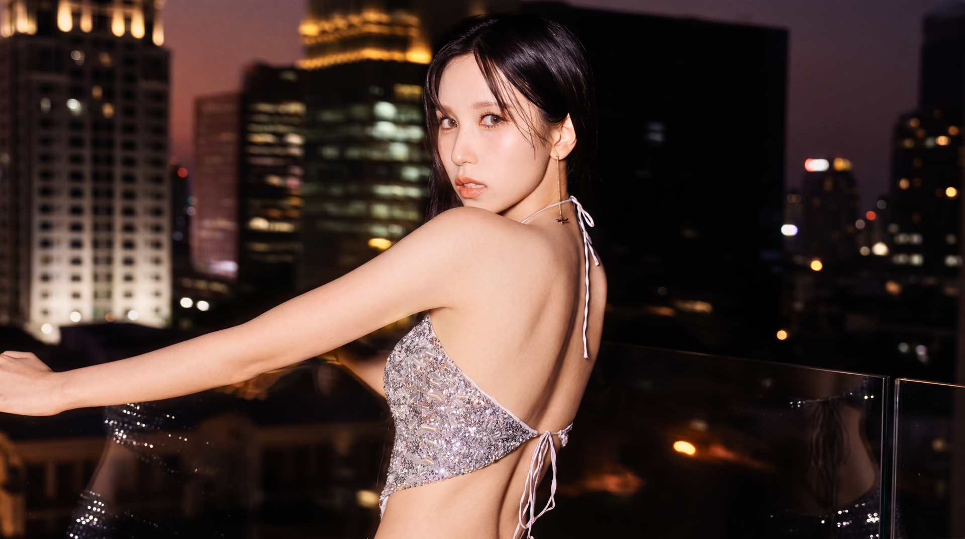 Japanese K-pop singer and model posing on a city rooftop at night in a sparkly backless top — 5K Ultra HD PC desktop wallpaper and background.