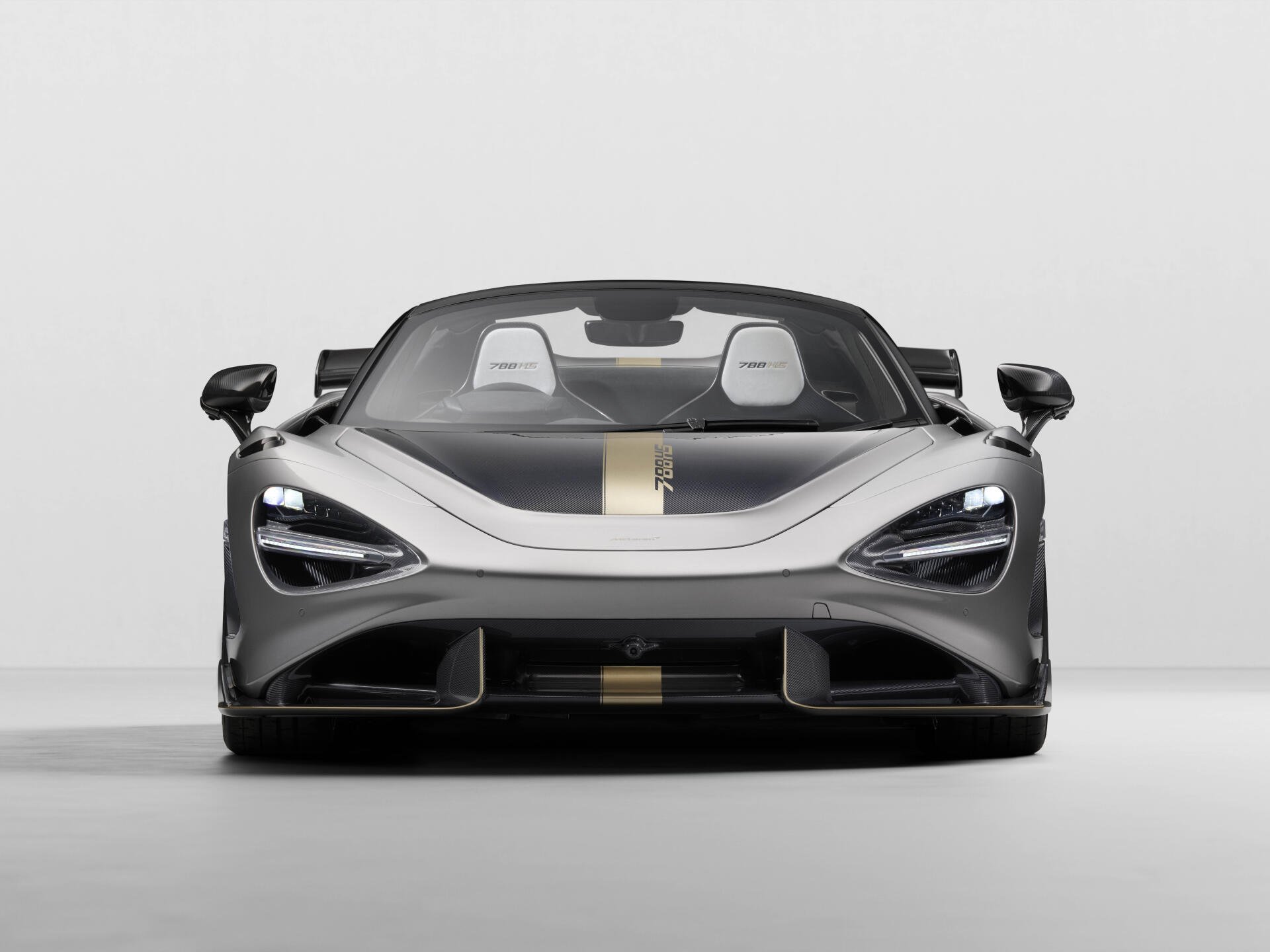 Front view of a silver McLaren 788HS sports car with a gold racing stripe, rendered as an 8K Ultra HD PC desktop wallpaper and background.