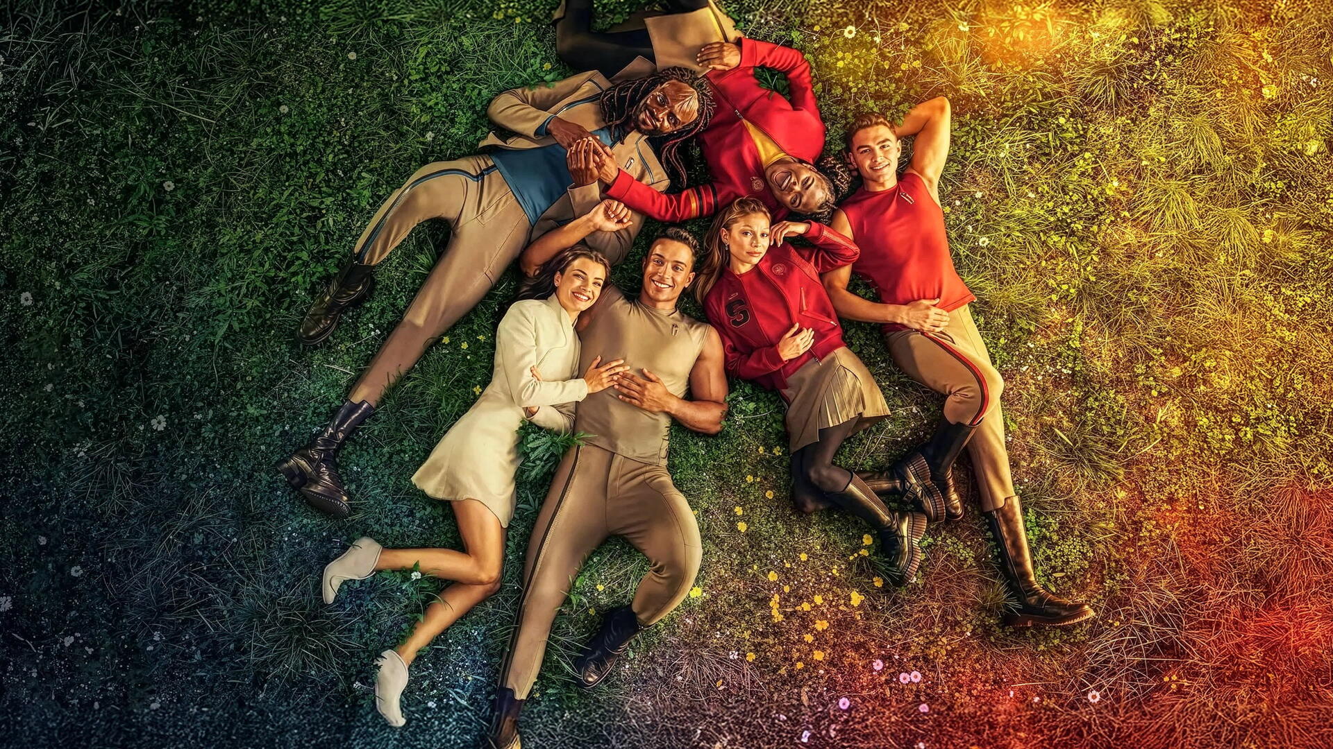 Star Trek: Starfleet Academy ensemble lying on a colorful grassy field in a vibrant 4K Ultra HD PC desktop wallpaper, rainbow lighting and relaxed group portrait evoking Star Trek atmosphere.