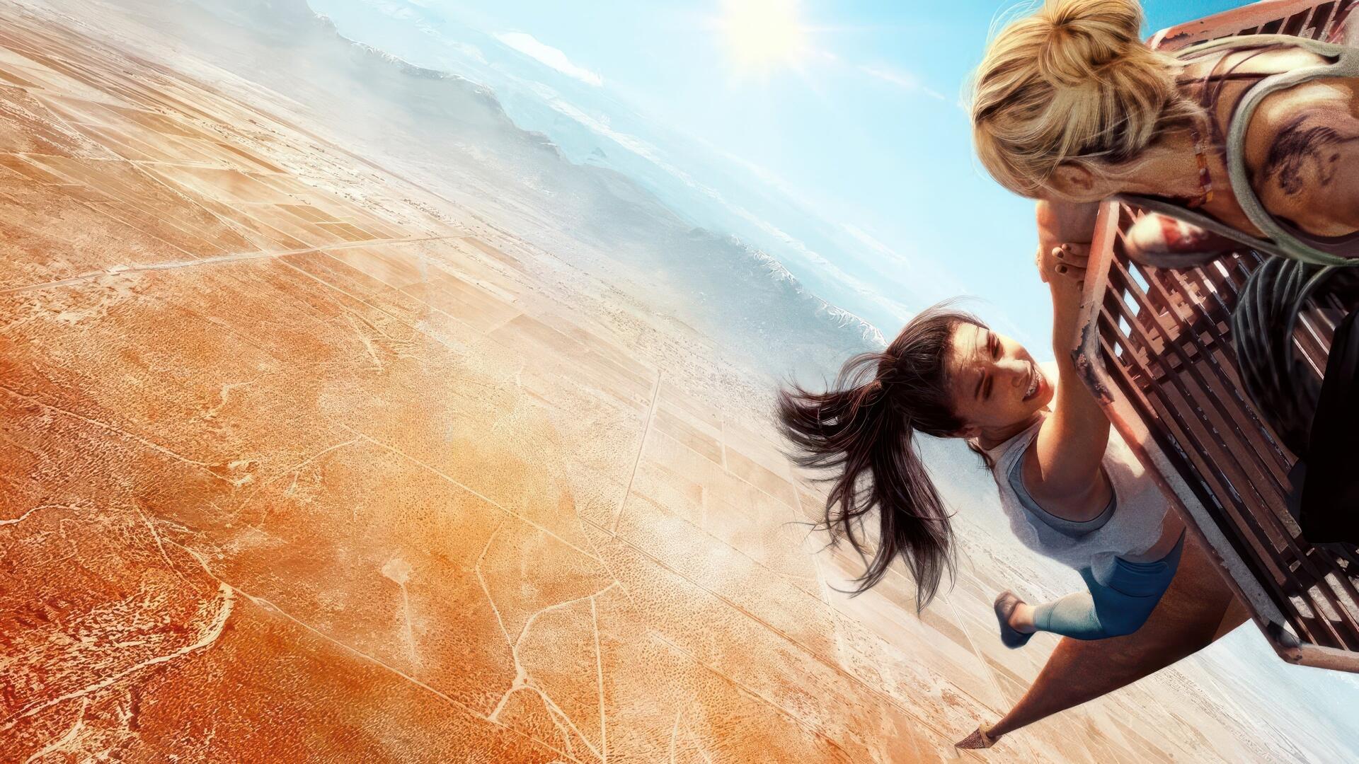 Vertigo 4K Ultra HD PC desktop wallpaper: two figures clutch a railing, hanging over a dizzying desert abyss with a sweeping sky and dramatic downward perspective.