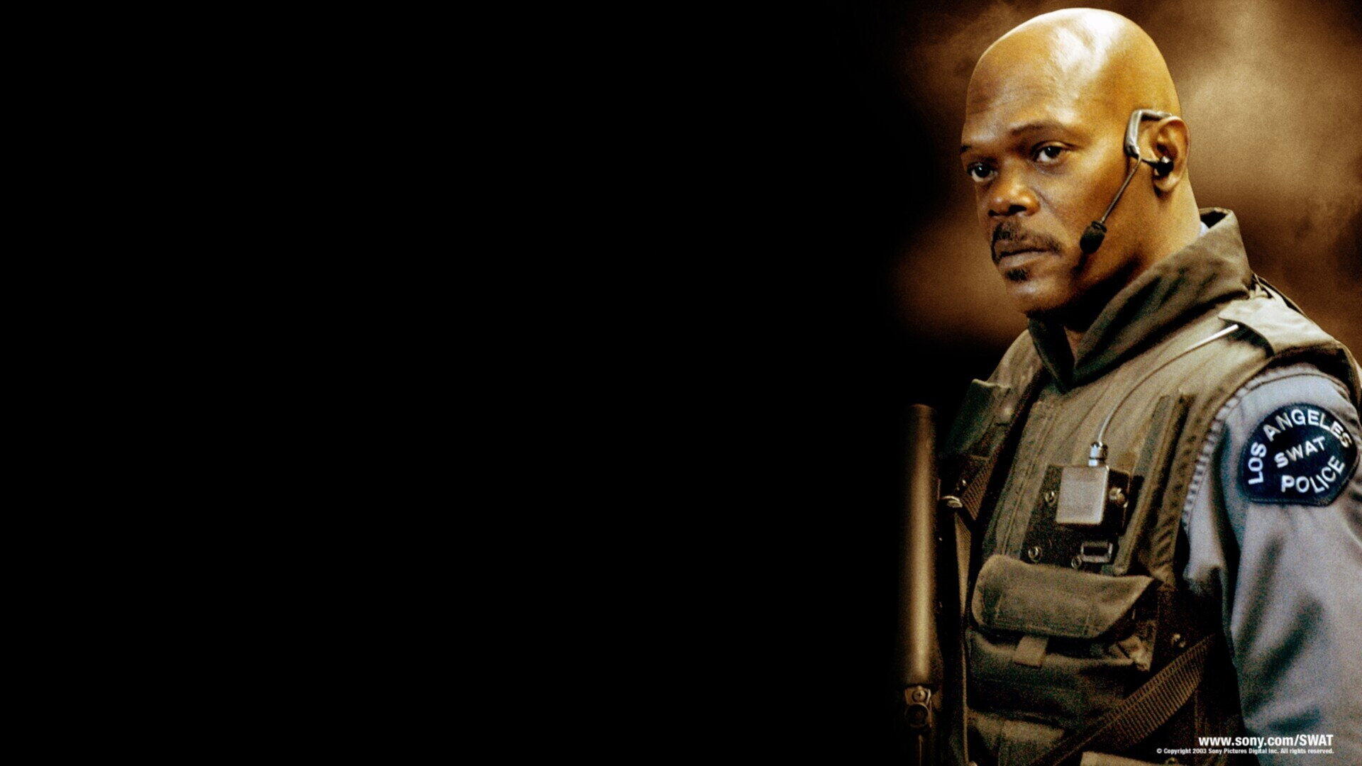 HD PC desktop wallpaper/background from S.W.A.T. (2003) showing a focused SWAT officer in tactical vest and earpiece against a dark background.