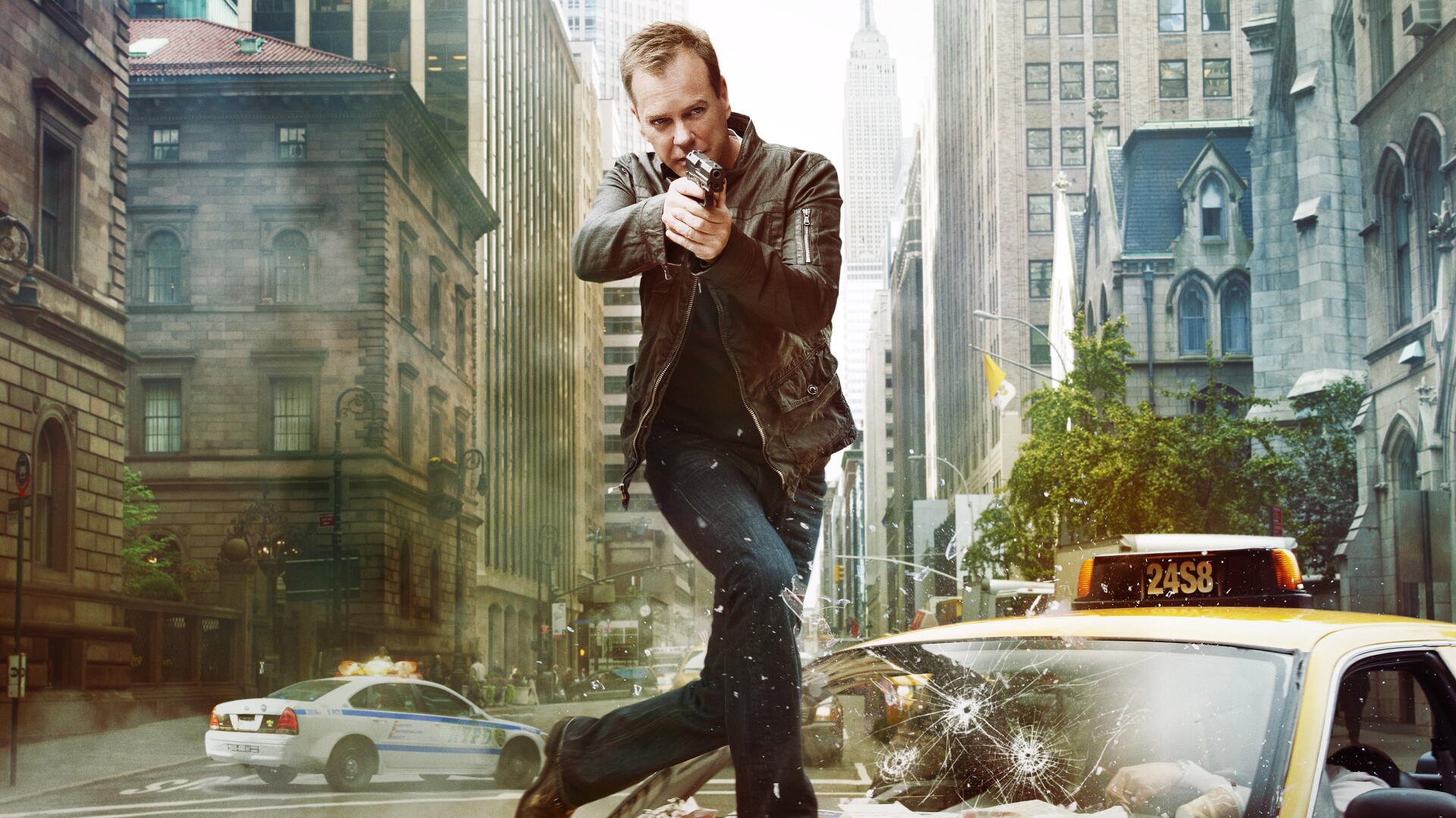 Unidentified man firing a gun while jumping over a shattered taxi amid police cars and city skyscrapers in a tense action shot. Tag: 24. 4K Ultra HD PC Desktop Wallpaper and Background.