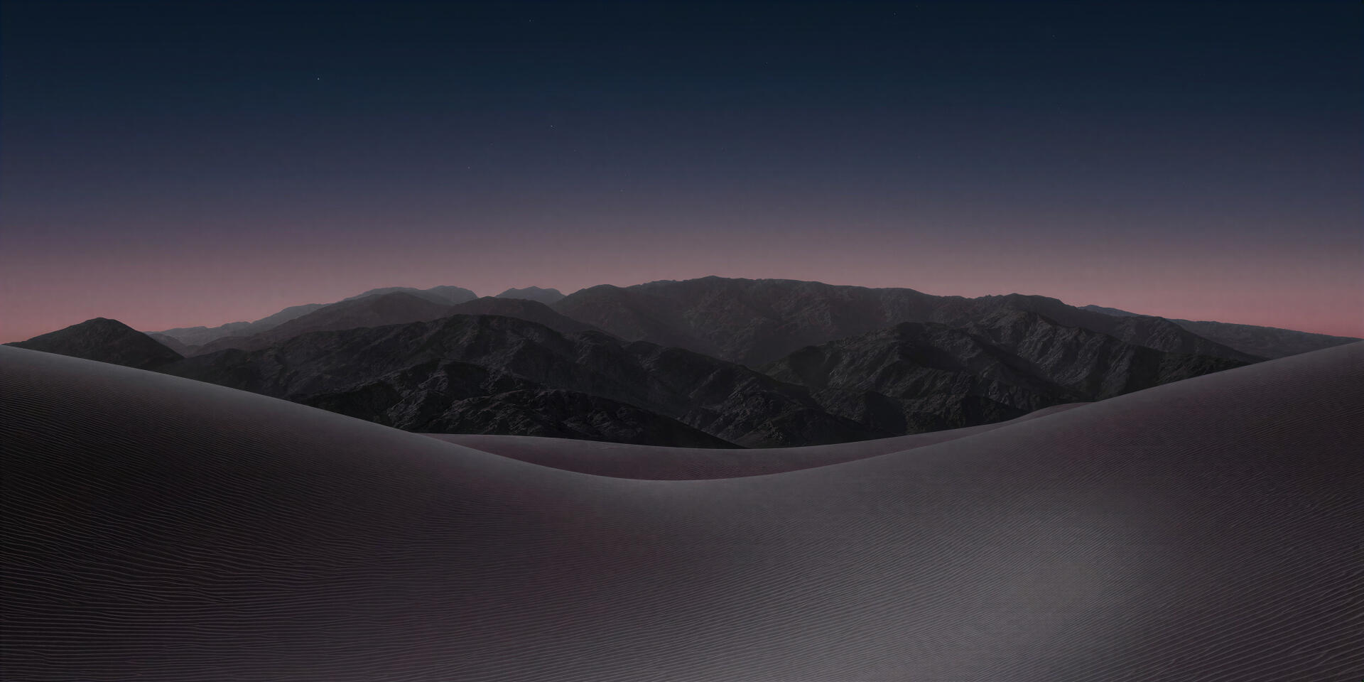 4K Ultra HD PC desktop wallpaper background (iPhone Duo, computer): smooth dark dunes leading to silhouetted mountain ridges under a deepening dusky sky.