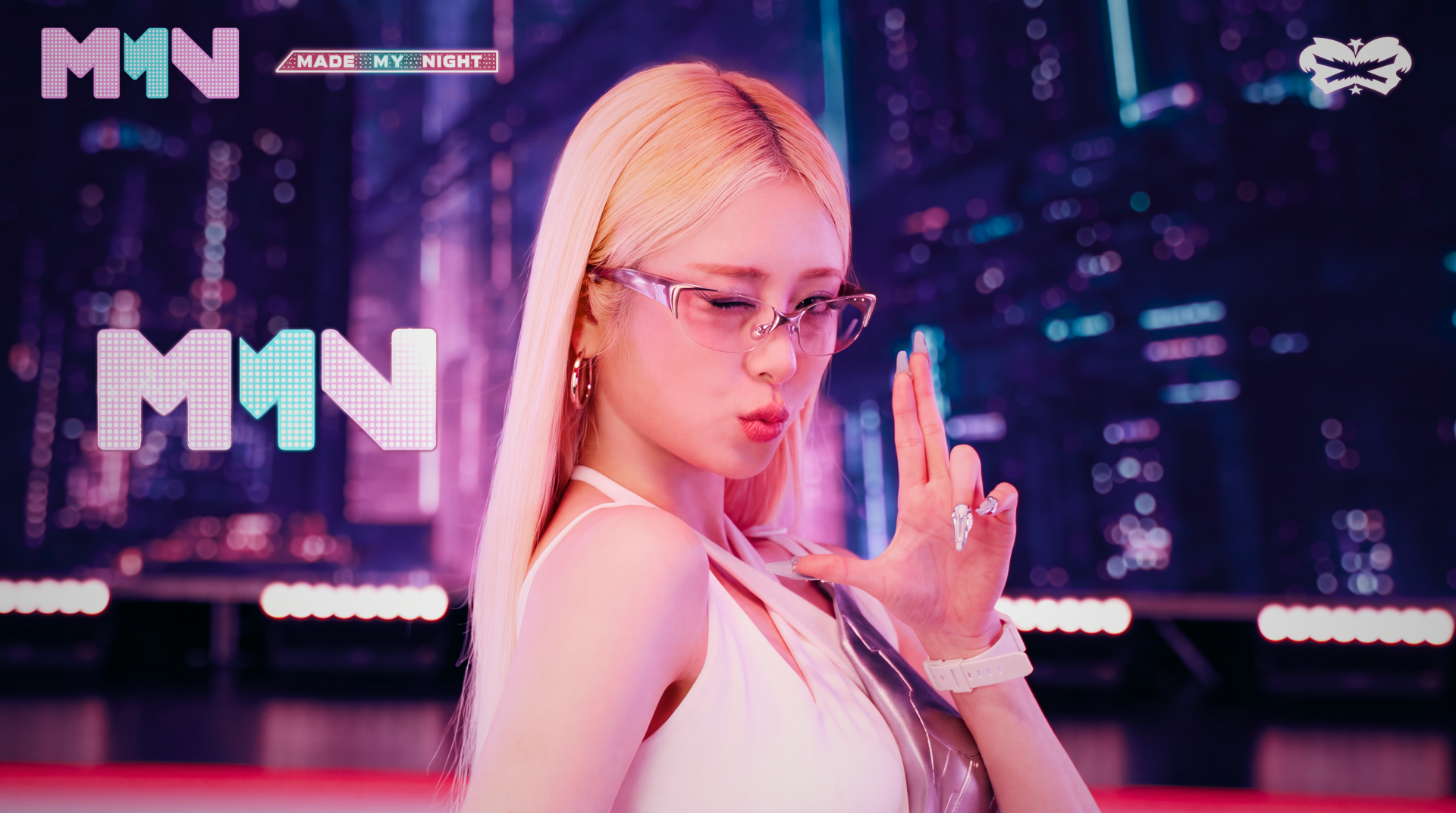Blonde K-pop idol in glasses striking a finger-gun pose against a neon, Overwatch 2–style cityscape; vibrant pink and cyan lighting, 5K Ultra HD PC desktop wallpaper.