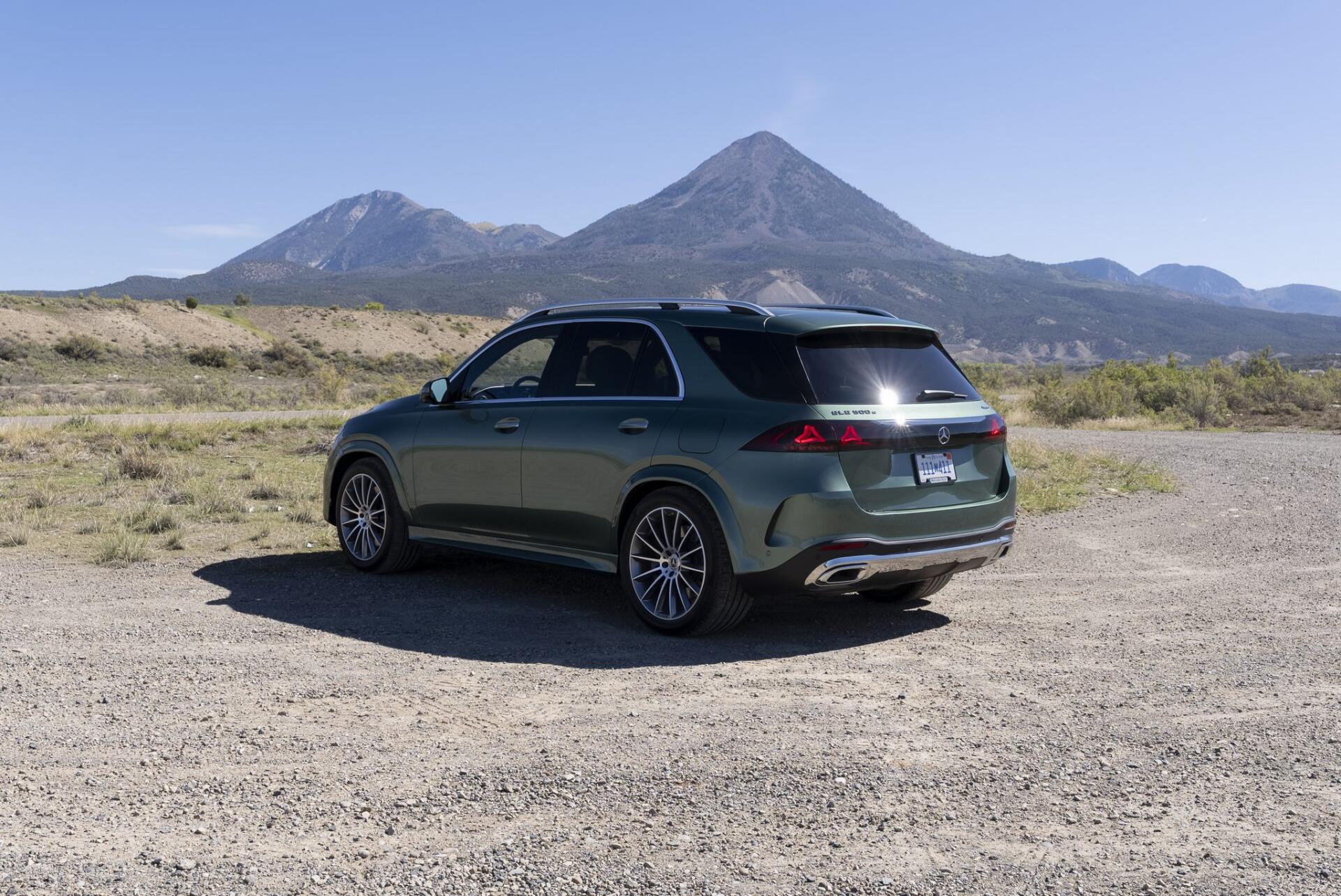 Mercedes-Benz GLS SUV parked against a mountain landscape, featured in an HD desktop wallpaper background.