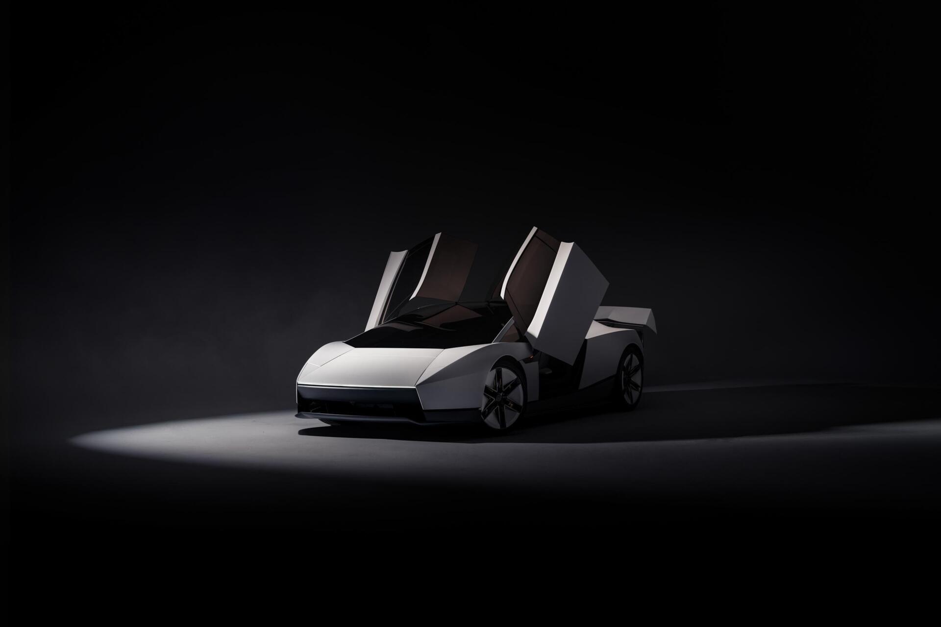 Tesla Roadster concept sports car with raised doors in a dark studio, featured in a 2K Quad HD PC desktop wallpaper.