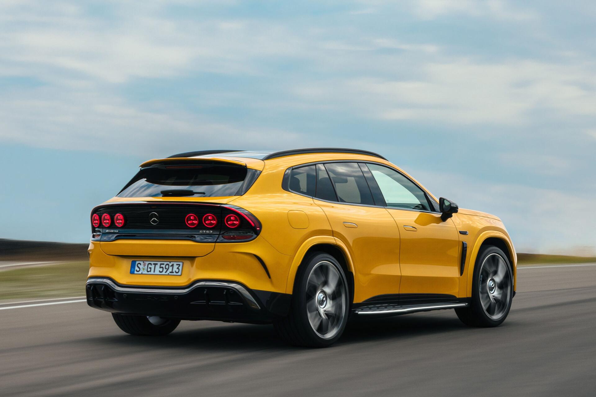 Yellow Mercedes-AMG GT SUV driving on a road, 2K Quad HD PC desktop wallpaper background.