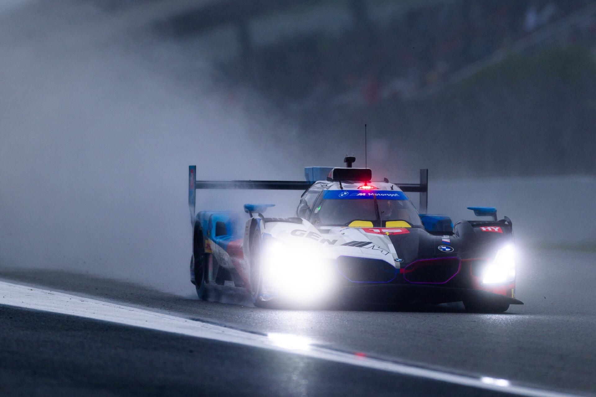 BMW M Hybrid V8 race car charges through a rain-soaked track in the FIA World Endurance Championship, HD desktop wallpaper.