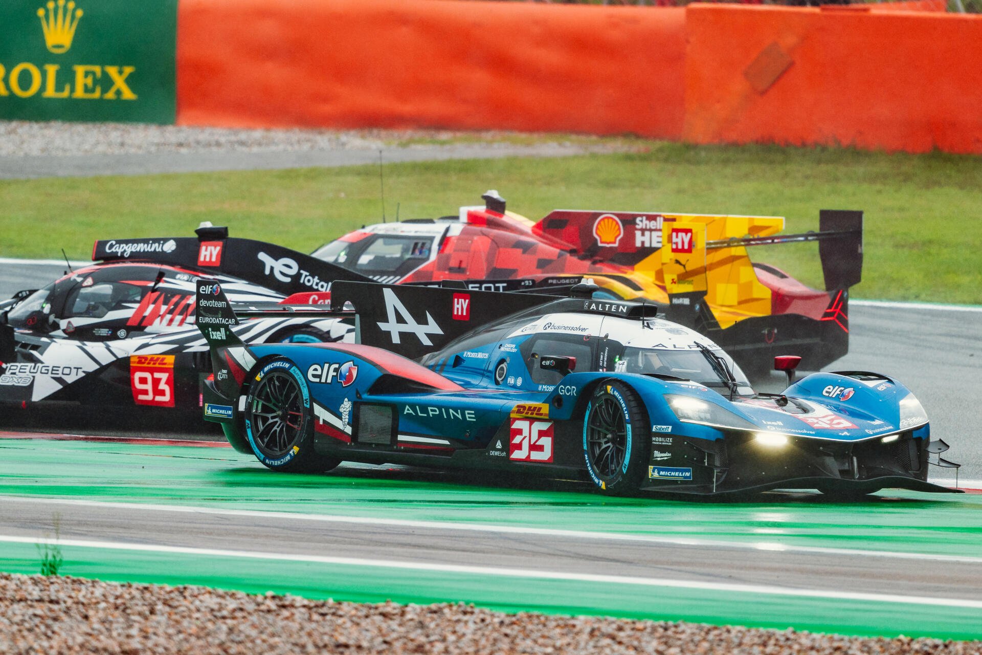 Alpine A424 race car battling on track in an auto racing scene, featured in a 5K Ultra HD PC desktop wallpaper.