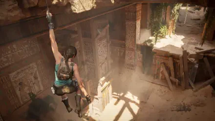 Video game 4K Ultra HD PC wallpaper of Lara Croft from Tomb Raider: Legacy of Atlantis leaping into a sunlit ancient tomb, ropes and carved walls casting dramatic shadows.
