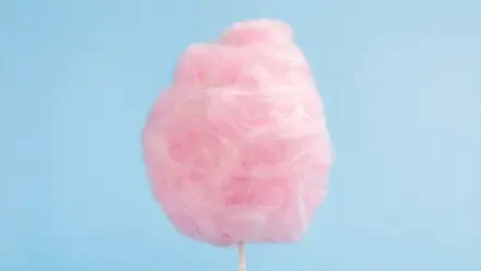 4K Ultra HD PC desktop wallpaper: pink cotton candy on a stick against a soft pale blue background.