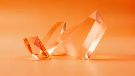 Orange aesthetic 4K Ultra HD PC desktop wallpaper: three translucent faceted crystals on a smooth orange gradient background.