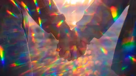 Holding hands in close-up at sunset, prismatic rainbow refractions and bokeh create a dreamy scene — 4K Ultra HD PC desktop wallpaper/background.