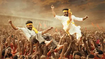 RRR 4K Ultra HD PC Desktop Wallpaper: two jubilant men in yellow scarves leaping above a roaring crowd under dramatic sunset skies, hands raised in celebration.