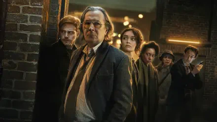 Slow Horses 4K Ultra HD PC desktop wallpaper: gritty night-alley scene of a ragged team of intelligence operatives led by a stern older man, moody lighting and brick urban backdrop.
