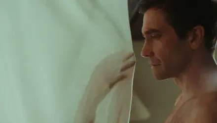 HD PC desktop wallpaper: profile of a shirtless man by a sheer curtain, contemplative and cinematic — still titled Remain.