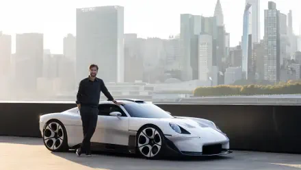 White Porsche Mission S electric sports car and man against a city skyline, 5K Ultra HD desktop wallpaper.