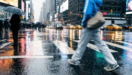 Rainy city street photography of a pedestrian crossing reflective pavement among taxis, 4K Ultra HD PC desktop wallpaper and background.