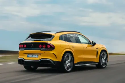 Yellow Mercedes-AMG GT SUV driving on a road, 2K Quad HD PC desktop wallpaper background.