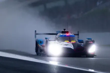 BMW M Hybrid V8 race car charges through a rain-soaked track in the FIA World Endurance Championship, HD desktop wallpaper.